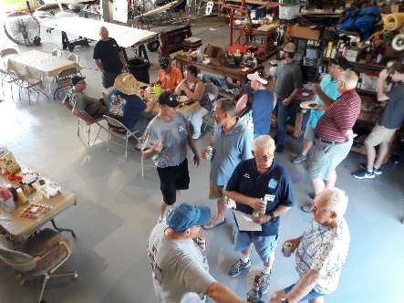 EAA Chapter 1298 members gathered in the hangar during a chapter event